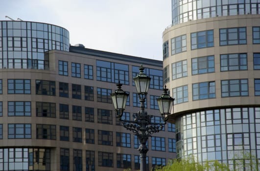historical lantern in front of modern architecture