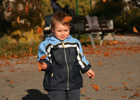 Child with autumn leaves