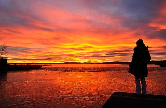 Girl at the lake at sunset