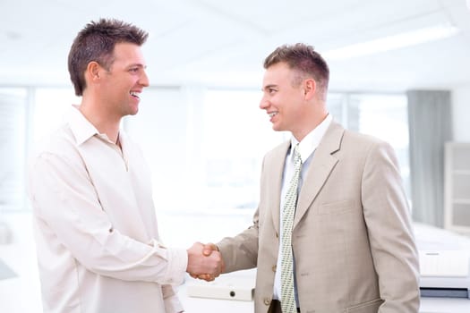 Businessmen shaking hands at office