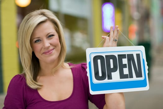 Pretty woman with open sign
