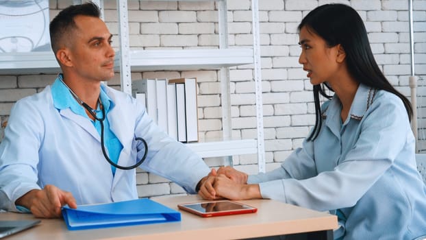 Doctor in professional uniform examining patient at hospital or medical clinic. Health care , medical and doctor staff service concept. Jivy