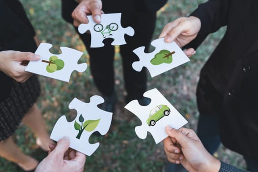 Business people or corporate partnership joining ECO friendly idea puzzle of jigsaw together as group of eco professional teamwork concept to promote social awareness on environmental protection. Gyre