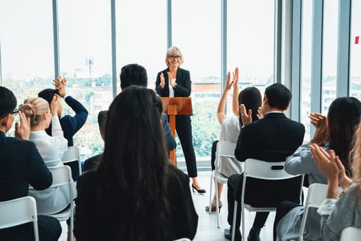 Group of business people meeting in a seminar conference . Audience listening to instructor in employee education training session . Office worker community summit forum with expert speaker . Jivy