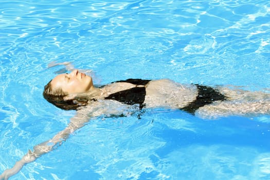 Woman swimming in outdoor pool