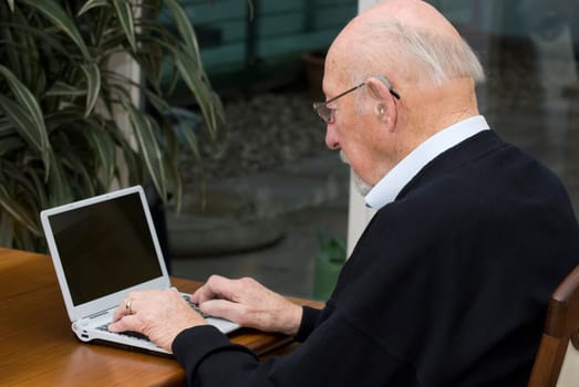 Active pensioner at notebook