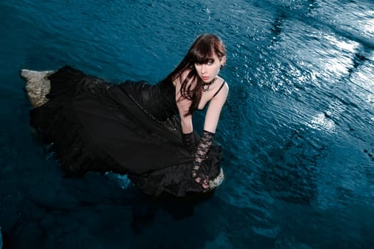 young woman on a stone in the water