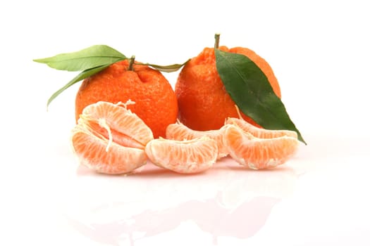 two mandarins with leaf and slices