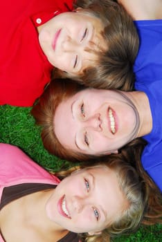 Family lying down on grass