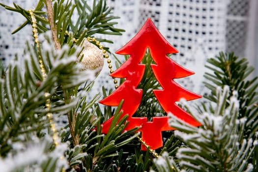 red christmas tree with green branches and hoarfrost