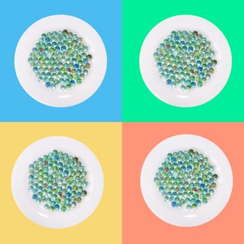 4 plates with glass marble in front of paint