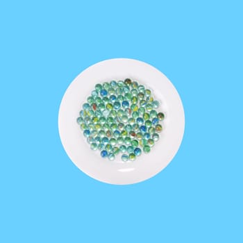 Plate with glass marbles from above - blue