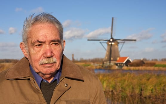 Old farmer and windmill