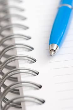 blue pen on notebook