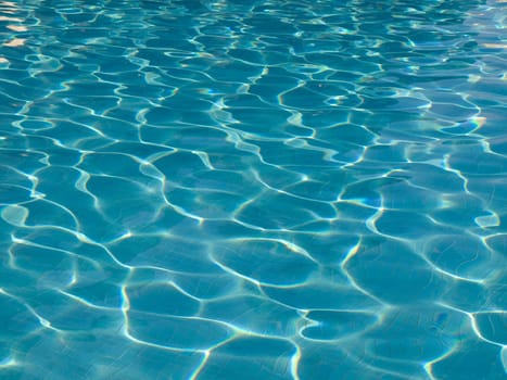 Light blue water surface of a pool