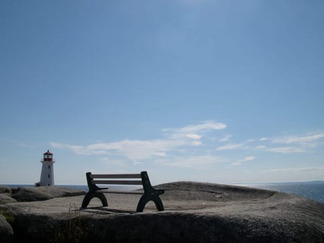 Bench at Peggys Cove with lighthouse