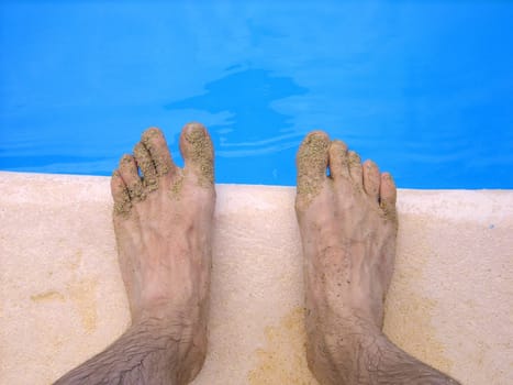 Feet by the water