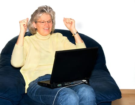Happy pensioner woman using laptop
