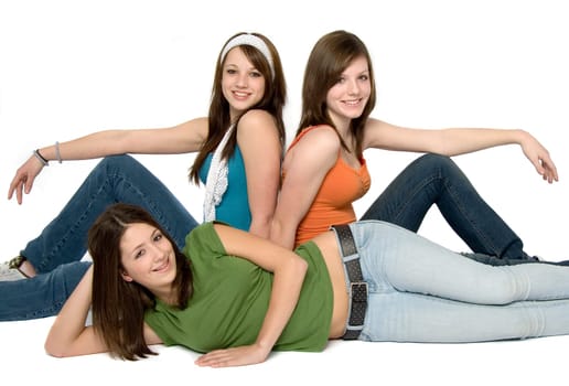 3 teen girls sitting. white background