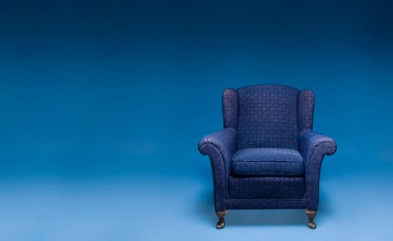 blue arm chair on blue background