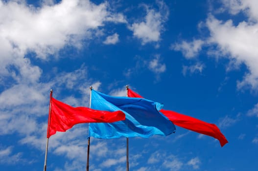 Blue and red flags flutter in the wind