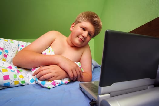 Teenager watching portable DVD player