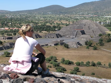 Woman sitting on sun pyramid