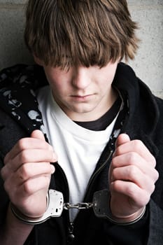 teen crime - kid in handcuffs