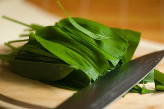 Wild garlic leaves on wooden board