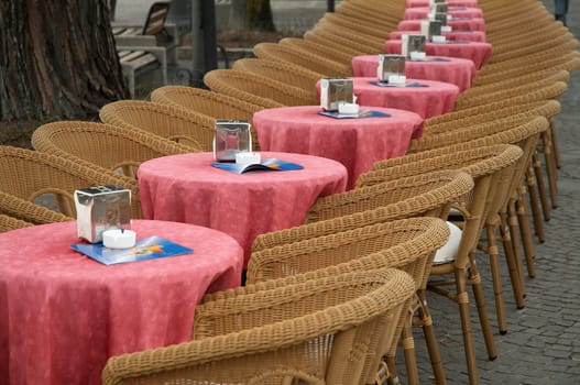 Empty tables and armchairs outdoors