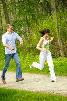 Happy couple in the park running