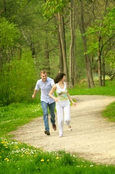 Happy couple in the park running