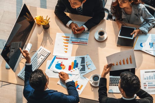 Business people group meeting shot from top view in office . Profession businesswomen, businessmen and office workers working in team conference with project planning document on meeting table . Jivy