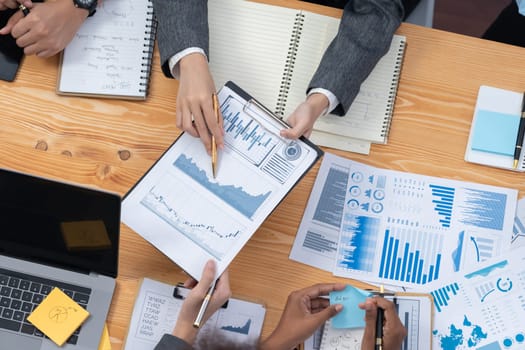 Flat top view workspace wooden table with analyst team use BI dashboard papers data for planning business strategy. Businesspeople utilize data analysis by FIntech for marketing indication. Concord