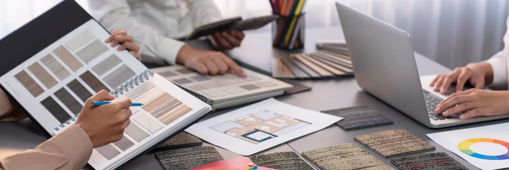 Group of interior designer team in meeting, discussing with engineer on interior design and planning for house project blueprint and model, choosing various mood board materials. Insight