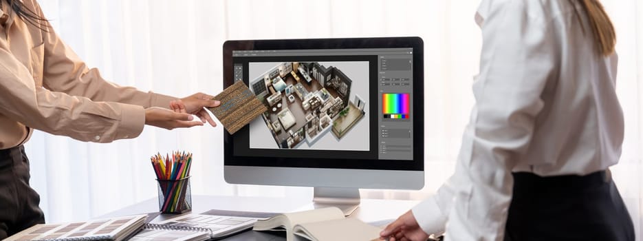 Group of interior architect designer team at table choosing various mood board samples with architecture software on laptop screen. Modern renovation and interior material selection concept. Insight