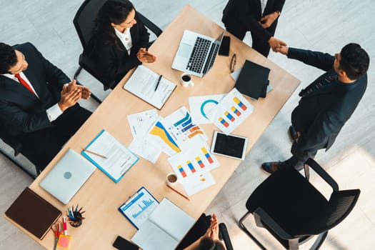 Business people group meeting shot from top view in office . Profession businesswomen, businessmen and office workers working in team conference with project planning document on meeting table . Jivy