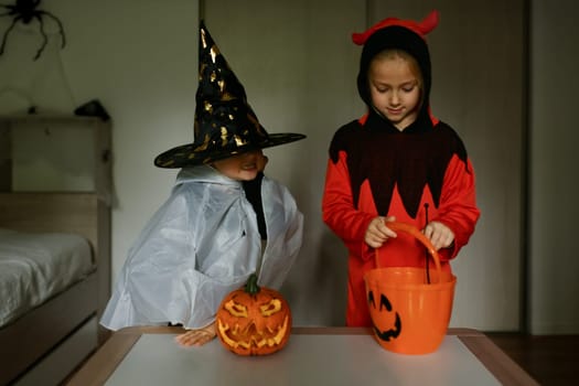 Children dressed as ghosts conjure at home on Halloween