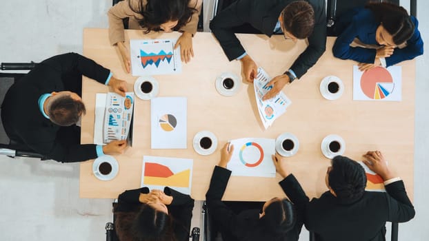 Business people group meeting shot from top view in office . Profession businesswomen, businessmen and office workers working in team conference with project planning document on meeting table . Jivy