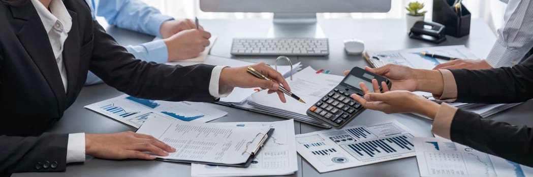 Auditor and accountant team working in office, analyze financial data and accounting record with calculator. Accounting company provide finance and taxation planning for profitable cash flow. Insight