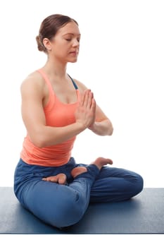 Beautiful sporty fit yogini woman meditates in yoga asana Padmasana - lotus pose with namaste