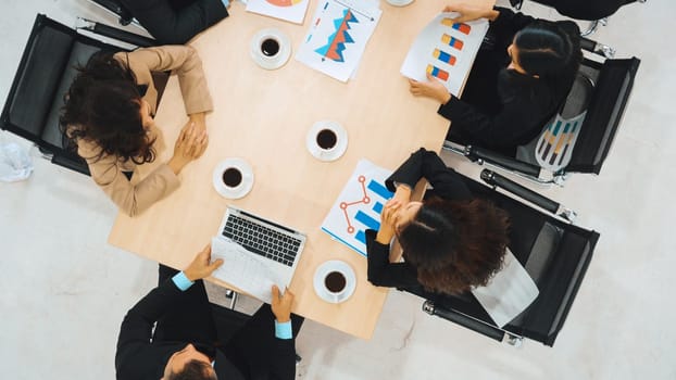 Business people group meeting shot from top view in office . Profession businesswomen, businessmen and office workers working in team conference with project planning document on meeting table . Jivy