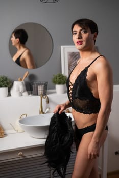 Homosexual preening in front of the mirror. A transgender man combing a wig