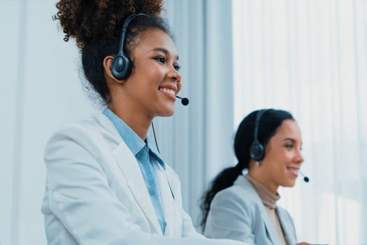 Business people wearing headset working in office to support remote customer or colleague. Call center, telemarketing, customer support agent provide service on telephone video conference call crucial