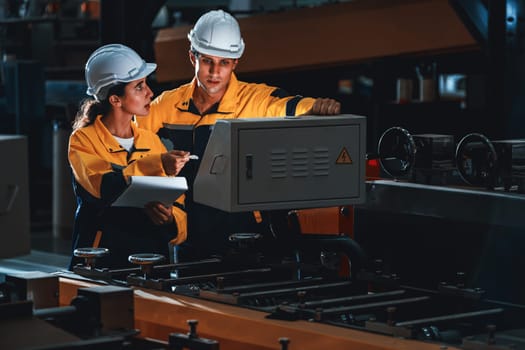 Professional quality control inspector conduct safety inspection on steel machinery and manufacturing process. Factory engineer or operator make optimization in heavy industry facility. Exemplifying