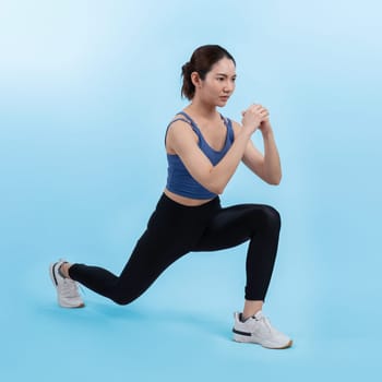 Young attractive asian woman in sportswear stretching before fitness exercise routine. Healthy body care workout with athletic woman warming up on studio shot isolated background. Vigorous