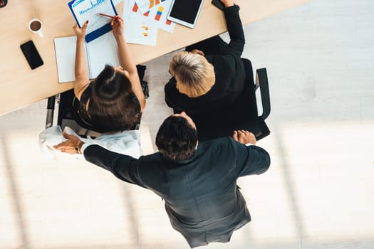 Business people group meeting shot from top view in office . Profession businesswomen, businessmen and office workers working in team conference with project planning document on meeting table . Jivy