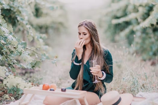 Picnic and wine tasting at sunset in the hills of Italy, Tuscany. Vineyards and open nature in the summer. Romantic dinner, fruit and wine.