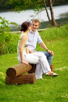Happy couple in park by lake