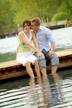 Happy couple in park by lake